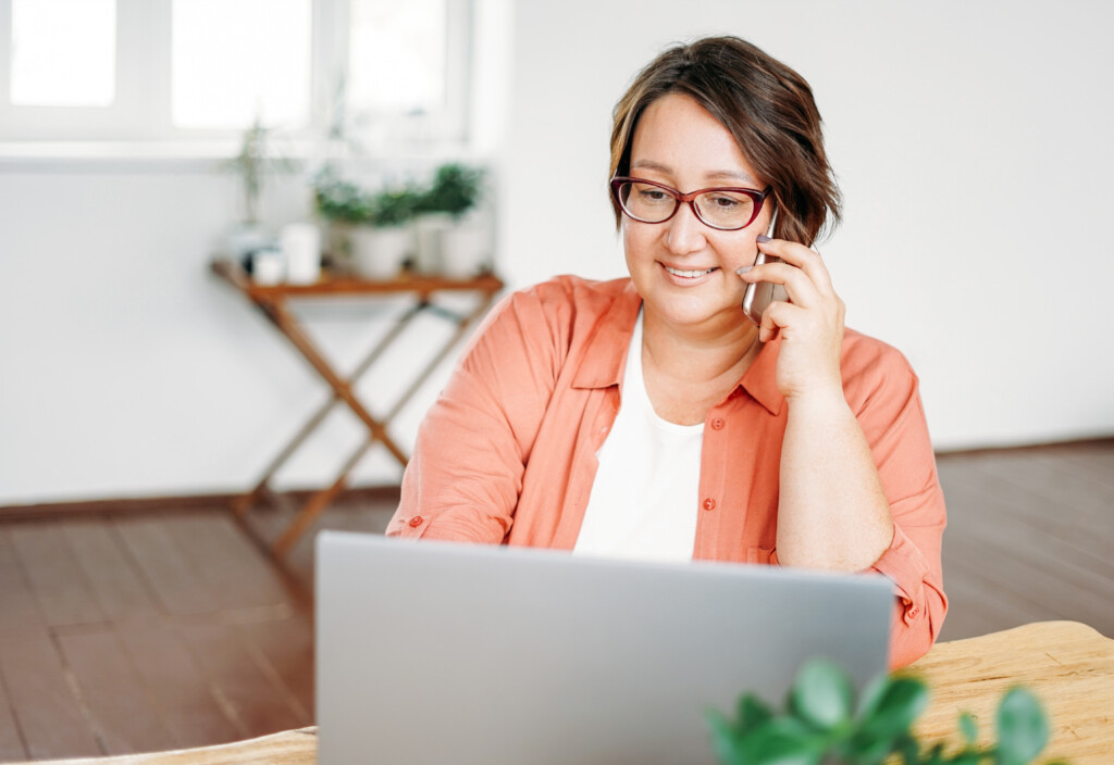 Adult Charming Brunette Woman In Glasses Plus Size Body Positive Working With Laptop At The Home